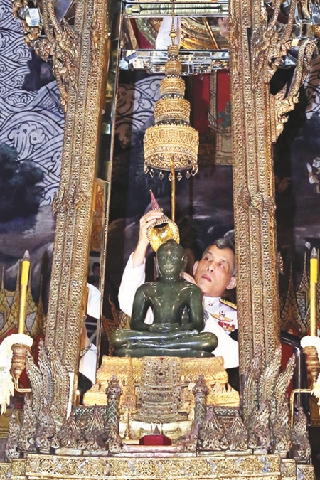 Phra Kaeo Morakot Emerald Buddha being tended to seasonally by His Majesty King Rama 10